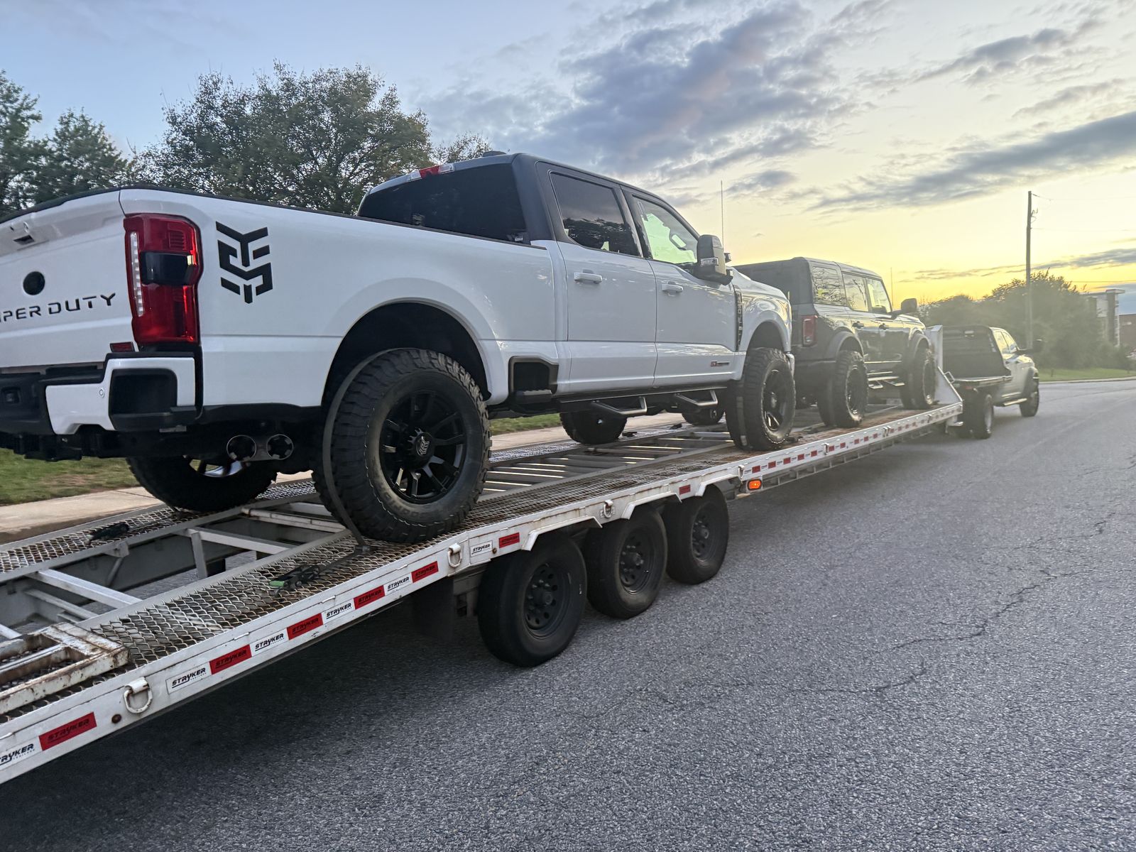 Rear view of the loaded car trailer at sunset